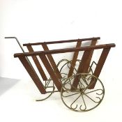 A 1960s/70s teak and metal novelty magazine rack in the form of a cart with rotating wheels (36cm