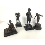 A set of four 1920s Burmese bronze figures including a Walking Man (25cm), a Water Carrier, Boy
