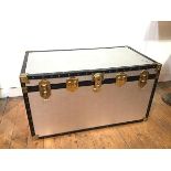 A vintage style travelling trunk with textured metal exterior, with paper interior, with Multiple