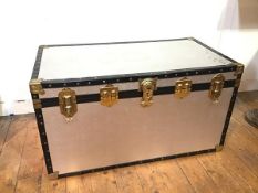 A vintage style travelling trunk with textured metal exterior, with paper interior, with Multiple