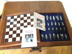 A Camelot chess set, the lift up mahogany game board over a fitted interior with Camelot themed
