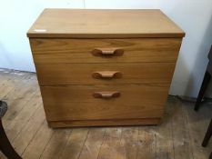A modern chest of drawers with rectangular top above three graduated drawers, on castors (70cm x