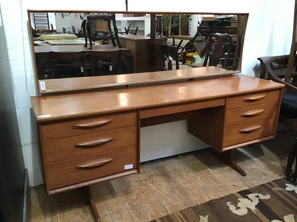 An Austinsuite teak dressing table, with long mirror above a rectangular top with single frieze