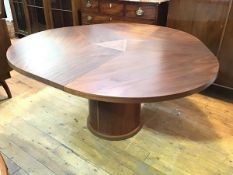 A Danish Skovby extendable dining table, the circular top expands to allow a sprung leaf section