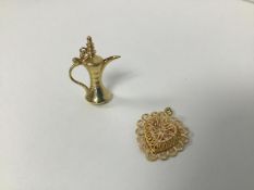 A yellow metal charm in the form of a Middle Eastern coffee pot (h.3cm) and a wirework heart (2) (