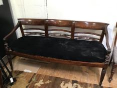 An early 20thc reproduction William IV style rosewood sofa with triple chair back above a caned seat