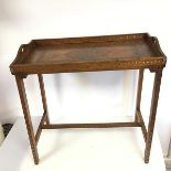 An Anglo Indian brass and copper inlaid folding table with handles to side and removable cross