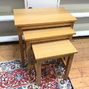 A set of three light oak nesting tables with rectangular tops on straight supports (largest: 55cm