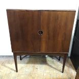 A rosewood cocktail cabinet, probably Danish of rectangular form with a pair of doors enclosing a