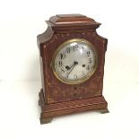 An Edwardian mahogany mantel clock, with C scroll and mother of pearl inlay, on brass bracket