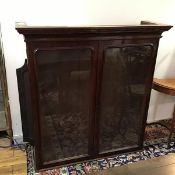 A Victorian mahogany bookcase, lacking base, with moulded cornice above a pair of glass panelled