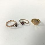 Three 9ct gold rings, including a signet style ring with three crosses (F), a crossover ring set two