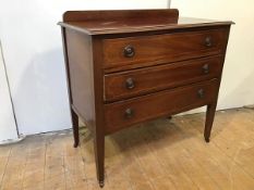 An Edwardian mahogany chest of drawers, the rectangular top with ledge back and moulded edge above