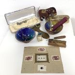 A mixed lot including paste pearls, magic tricks, two glazed bowls, a silver clothes brush depicting