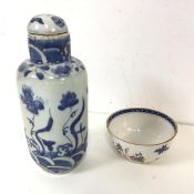 A Chinese blue and white bottle with stopper, with foliate decoration and a Chinese Export tea cup