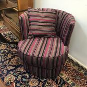 A modern tub chair in striped purple, blacks and grey fabric, with additional scatter cushion (