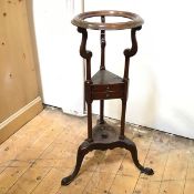 A Georgian plant stand, the circular top with moulded edge on S scroll supports, with a two drawer