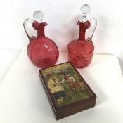 Two cranberry glass vases, one of flask form (cracks to neck), the other of mallet form with an