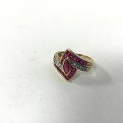 A Fraser Hart 9ct gold stylised navette dress ring with central ruby with radiating calibre rubies