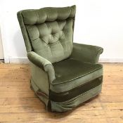 A 1960s recliner in olive green upholstery, with button back and scroll arms, with rocking mechanism