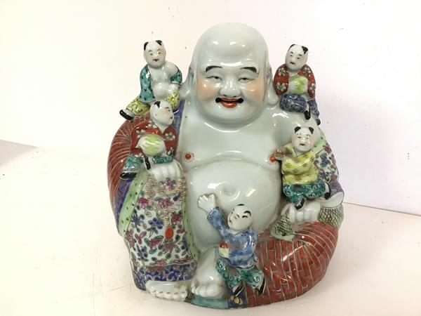 A modern ceramic seated Buddha, with five children (24cm x 27cm x 15cm)