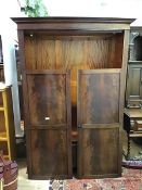 An Edwardian mahogany bow front two door wardrobe with boxwood inlay, the interior fitted hanging