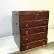 A modern mahogany jewellery chest, with hinged top over a shallow recess with slide and four