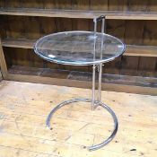 An Eileen Gray style side table, with circular glass top on metal frame, adjustable height (full
