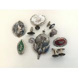 A group of Thai enamelled silver jewellery comprising five brooches, including a large peacock