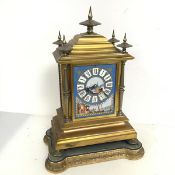 A 19thc French ormolu mantel clock, the stepped top with five finials above a central ceramic tile