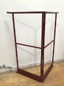 A Japanese red lacquer kimono stand, the top rails with flared ends, with central hanging rail and