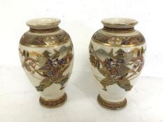A pair of 1950s Satsuma baluster vases, both depicting Warrior Fighting Dragon (22cm x 13cm)