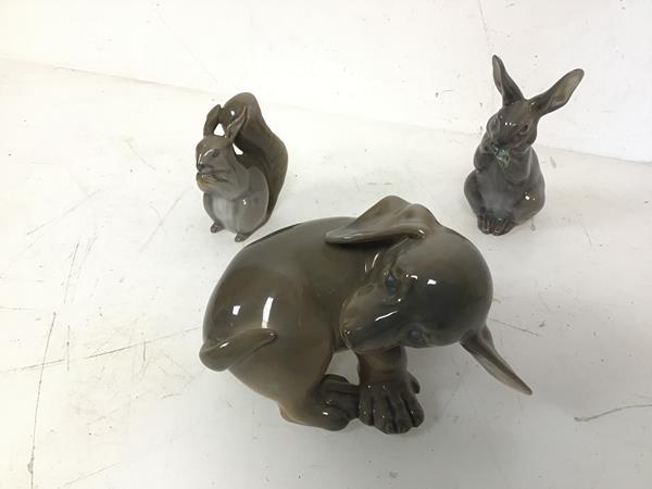 A group of three Royal Copenhagen animal figures including Puppy Chasing Tail (8cm x 12cm x 8cm),
