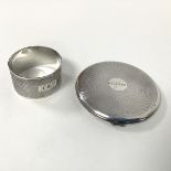 A silver napkin ring with engine turned decoration (2.5cm x 4.5cm) (22.31g) and an engine turned