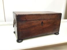 A 19thc mahogany tea caddy with shell inlay to top above a fitted interior (lacking bowl), with lion