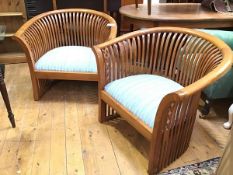 A pair of large contemporary verandah style slat back open armchairs, each with boldly outcurved