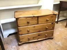 A modern pine small chest with serpentine moulded edge top above two short and two long drawers,