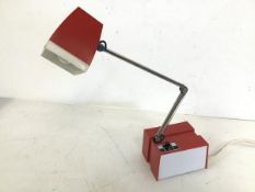 A 1980s Japanese desk lamp, in red and white acrylic, with adjustable arm and a hi and low