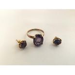 A single stone amethyst ring, high claw set on a yellow metal band (unmarked) together with a pair