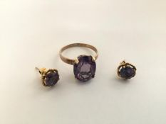 A single stone amethyst ring, high claw set on a yellow metal band (unmarked) together with a pair