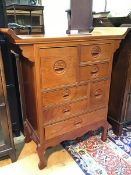 A modern Chinese hardwood side cabinet, the channelled top with upward curved sides, above an