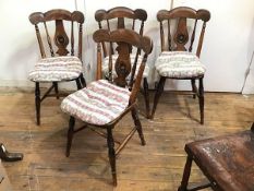A set of four Edwardian mahogany dining chairs with yoke top rail on turned supports and central