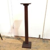 An oak pedestal with square top on four sided fluted stem and moulded square base (91cm x 17cm x