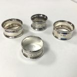 A pair of Sheffield silver napkin rings (each: 2cm x 5cm) and two other silver napkin rings (