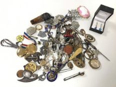 An assortment of silver and costume jewellery including pendants, badges, cameos, rings (a lot)