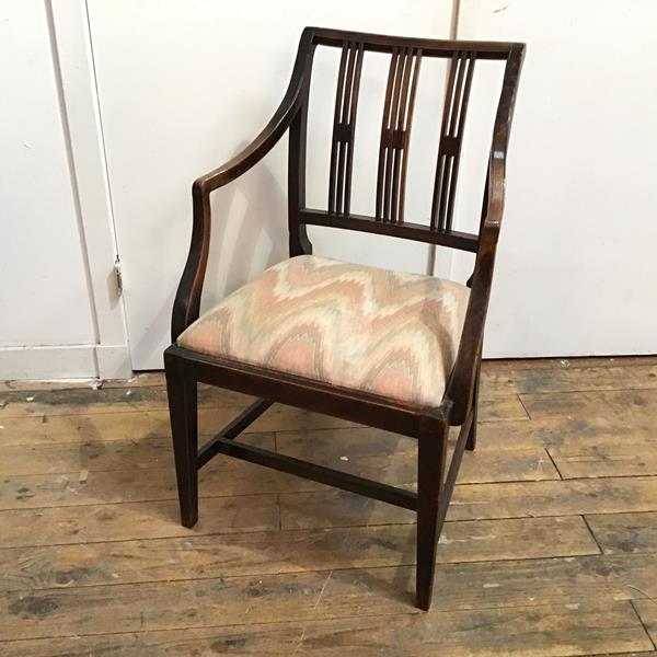 A Regency mahogany open armchair with three pierced splats, with drop in seat, on tapering