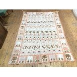 A 1930s/40s wall hanging with repeating pattern of animals, some with riders, within a border of