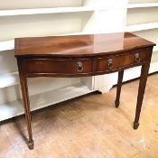 A reproduction mahogany side table, with serpentine front, fitted two frieze drawers, with lion mask