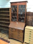 An Edwardian mahogany bureau bookcase the interior fitted with central inlaid compartment with shell