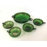 A green glass two handled punch bowl, c1900 (6cm x 28cm x 21cm), together with four squat matching